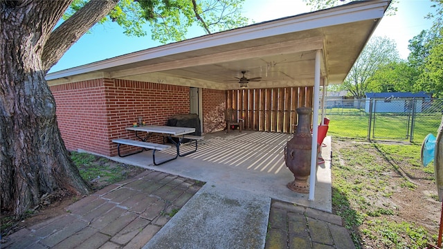 view of patio with a ceiling fan, a gate, and fence