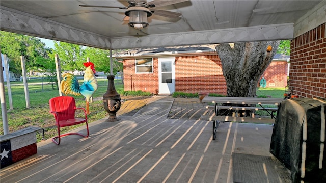 deck featuring a yard and ceiling fan
