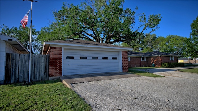 view of front of house featuring fence, a garage, and brick siding