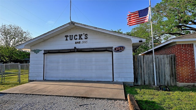 detached garage featuring fence