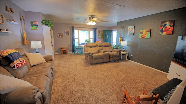 living room featuring carpet, a textured wall, baseboards, a ceiling fan, and a textured ceiling