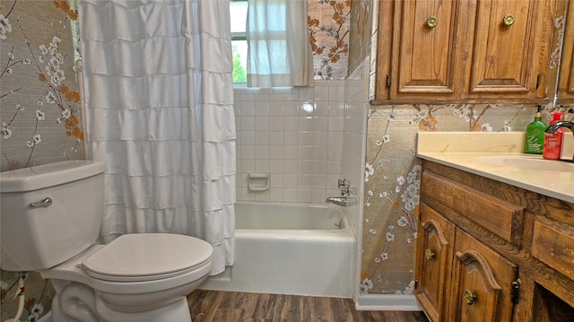full bathroom featuring wood finished floors, toilet, shower / bath combination with curtain, and vanity