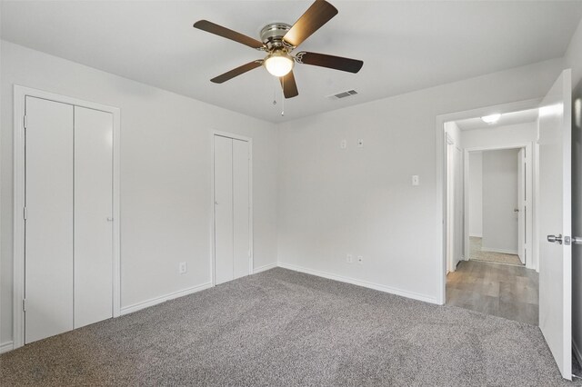 829 Hunters Creek Dr, Desoto, TX 75115 - unfurnished bedroom with carpet flooring, ceiling fan, visible vents, baseboards, and multiple closets