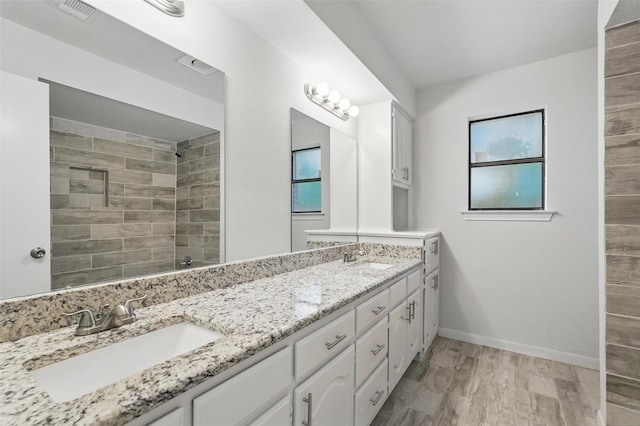 829 Hunters Creek Dr, Desoto, TX 75115 - full bathroom featuring a tile shower, double vanity, a sink, and visible vents