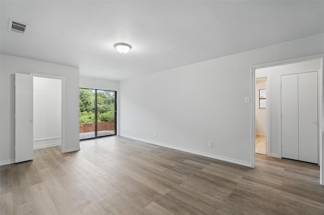 829 Hunters Creek Dr, Desoto, TX 75115 - unfurnished bedroom featuring wood finished floors, visible vents, access to exterior, and baseboards