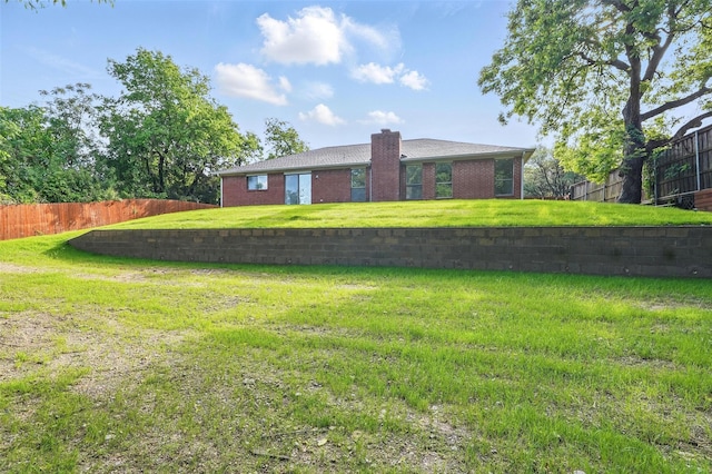 829 Hunters Creek Dr, Desoto, TX 75115 - rear view of house featuring a yard, brick siding, a chimney, and fence