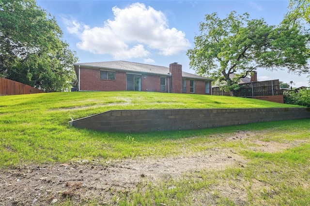 829 Hunters Creek Dr, Desoto, TX 75115 - back of house with a chimney, brick siding, fence, and a lawn