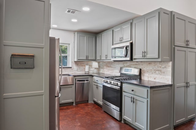 250 Creek Crossing St, Alvord, TX 76225 - kitchen featuring appliances with stainless steel finishes, gray cabinetry, decorative backsplash, finished concrete floors, and recessed lighting