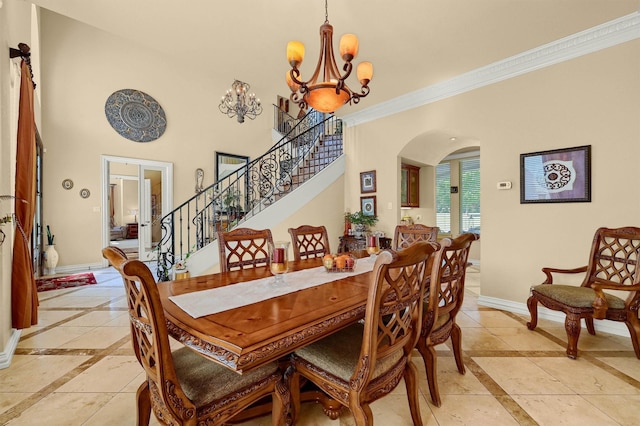 dining area with arched walkways, an inviting chandelier, stairs, ornamental molding, and baseboards