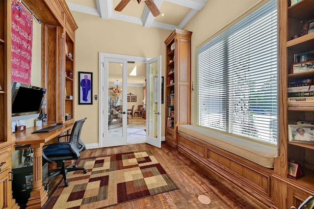 office with beamed ceiling, wood finished floors, french doors, and a healthy amount of sunlight