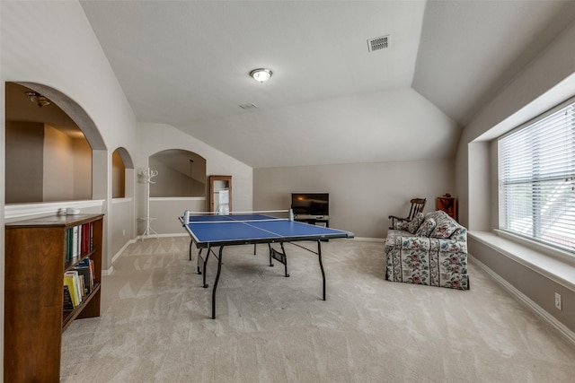 game room with visible vents, arched walkways, vaulted ceiling, and carpet floors