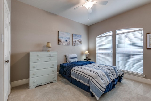 carpeted bedroom featuring baseboards and ceiling fan