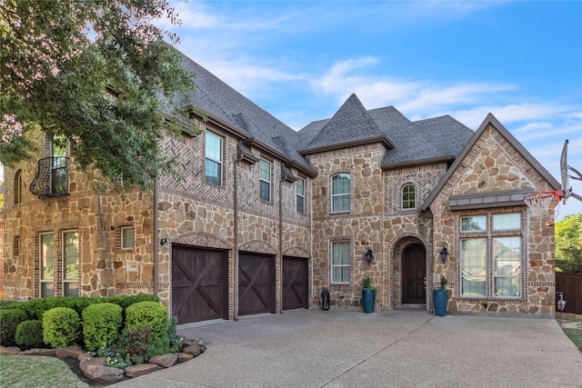 3040 N Camino Lagos, Grand Prairie, TX 75054 - french country inspired facade with driveway, a garage, a shingled roof, and stone siding