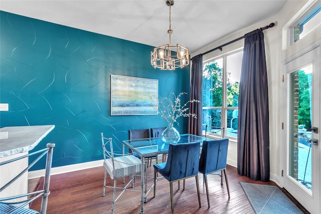 3040 N Camino Lagos, Grand Prairie, TX 75054 - dining area with an accent wall, wood finished floors, a notable chandelier, and baseboards