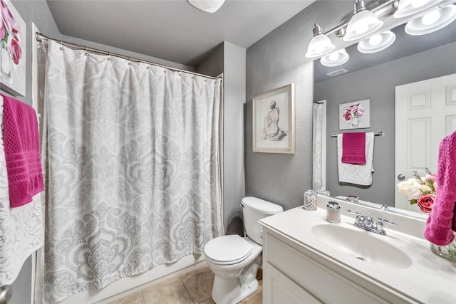 3040 N Camino Lagos, Grand Prairie, TX 75054 - full bath with tile patterned flooring, shower / bath combo, toilet, a textured wall, and vanity