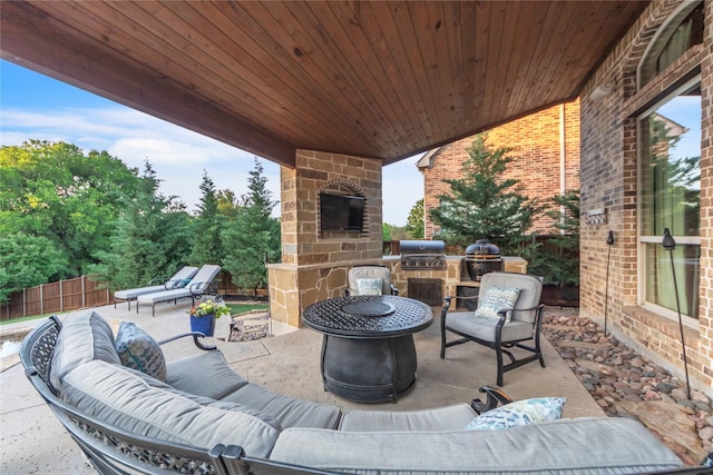3040 N Camino Lagos, Grand Prairie, TX 75054 - view of patio featuring an outdoor kitchen, fence, area for grilling, and an outdoor living space with a fire pit