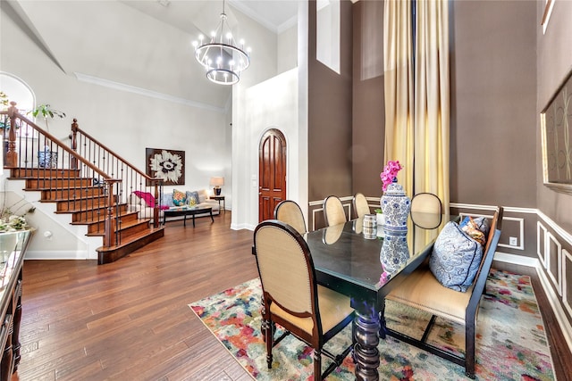 3040 N Camino Lagos, Grand Prairie, TX 75054 - dining room with wood finished floors, stairs, a notable chandelier, a high ceiling, and crown molding