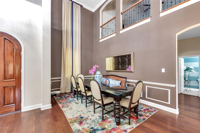 3040 N Camino Lagos, Grand Prairie, TX 75054 - dining space featuring baseboards, arched walkways, a high ceiling, and wood finished floors