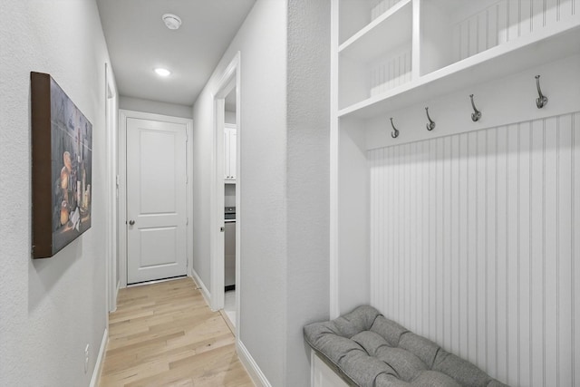 mudroom featuring baseboards, recessed lighting, and light wood finished floors