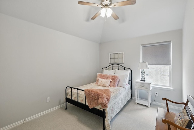 carpeted bedroom featuring a ceiling fan, vaulted ceiling, and baseboards