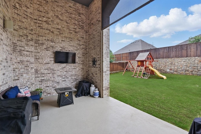 view of patio featuring a fenced backyard and a playground