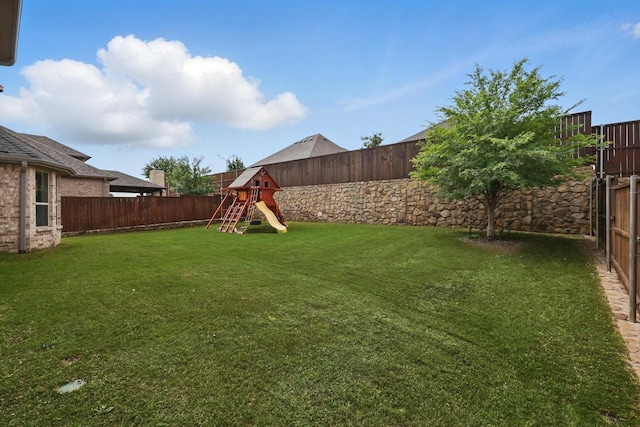 view of yard featuring a playground and a fenced backyard