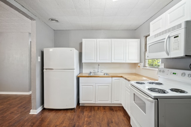 1206 E SE 2nd Ave, Mineral Wells, TX 76067 - kitchen featuring white appliances, white cabinets, dark wood-style flooring, a sink, and visible vents
