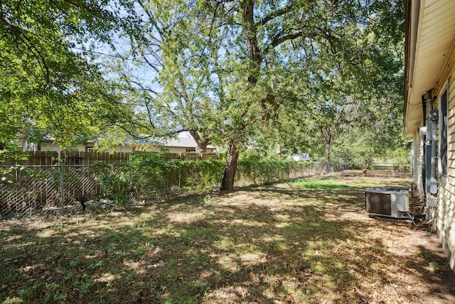 1206 E SE 2nd Ave, Mineral Wells, TX 76067 - view of yard with a fenced backyard and central AC unit