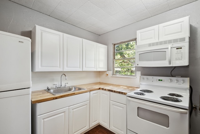 1206 E SE 2nd Ave, Mineral Wells, TX 76067 - kitchen featuring white cabinets, a sink, wood counters, and white appliances