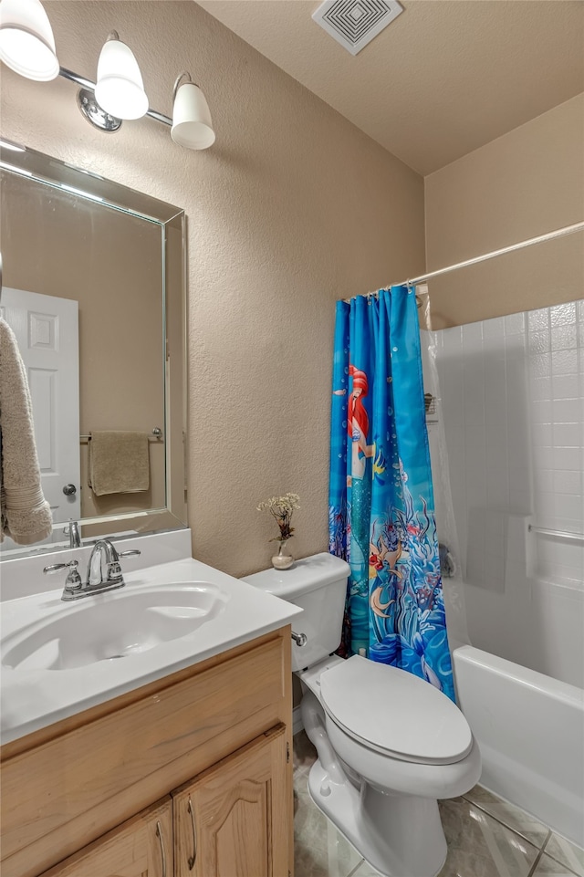 bathroom with vanity, toilet, shower / tub combo, visible vents, and a textured wall