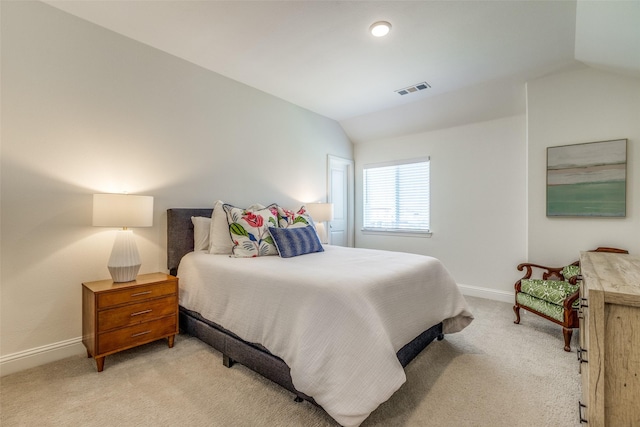 bedroom featuring visible vents, vaulted ceiling, light colored carpet, and baseboards
