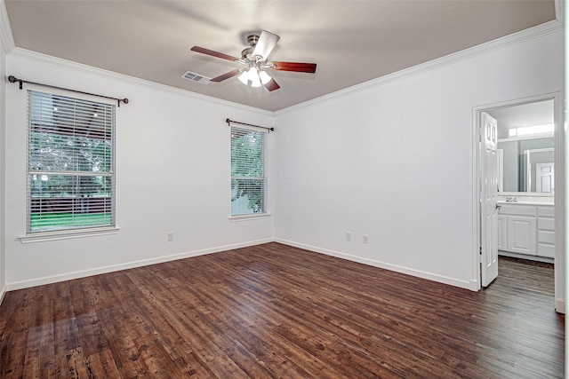empty room with ceiling fan, dark wood-style flooring, baseboards, visible vents, and crown molding