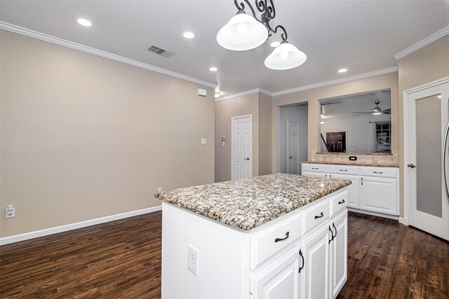 827 Huebner Way, Burleson, TX 76028 - kitchen featuring dark wood-type flooring, ornamental molding, a center island, pendant lighting, and light stone counters