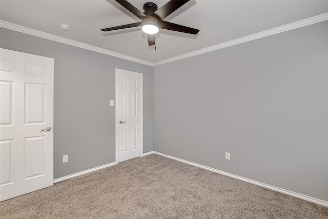 unfurnished bedroom with ceiling fan, baseboards, ornamental molding, and carpet flooring