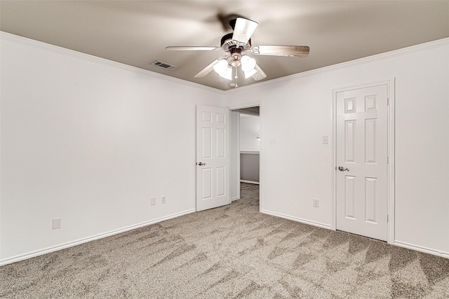 unfurnished bedroom featuring crown molding, visible vents, carpet, and baseboards