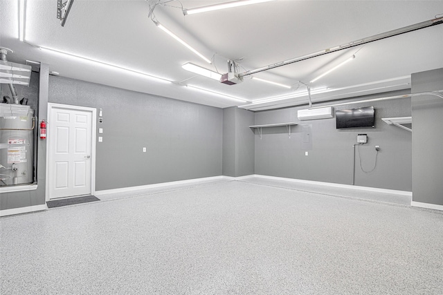 garage featuring gas water heater, a garage door opener, and baseboards