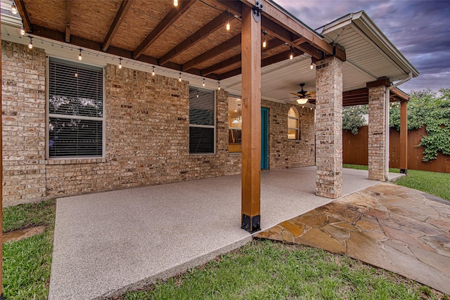view of patio with fence and a ceiling fan
