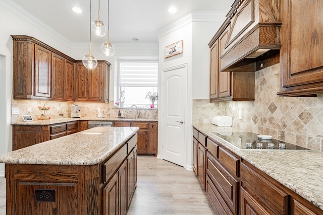 kitchen featuring light stone countertops, black electric stovetop, custom range hood, and a sink