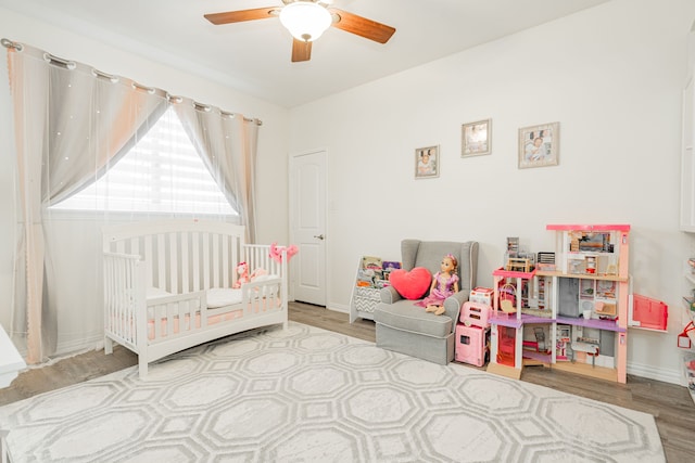 bedroom featuring wood finished floors, ceiling fan, and baseboards