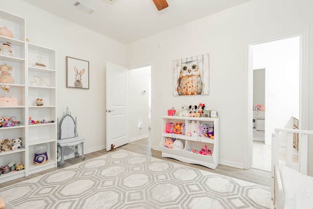playroom featuring visible vents, ceiling fan, baseboards, and light wood-style floors