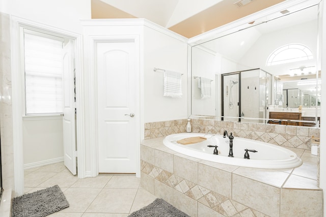 full bathroom featuring a shower stall, a healthy amount of sunlight, a garden tub, tile patterned flooring, and lofted ceiling
