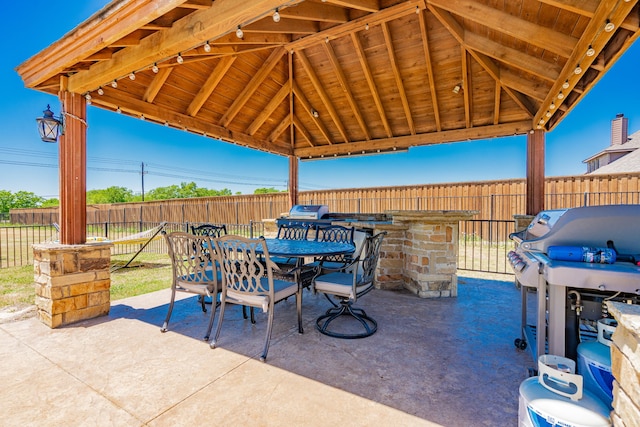 view of patio / terrace with outdoor dining area, a gazebo, and a fenced backyard