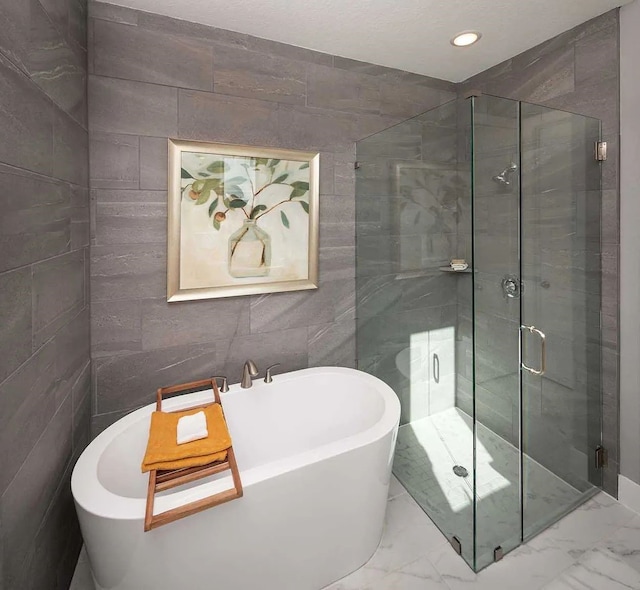 bathroom featuring a freestanding tub, a stall shower, recessed lighting, and marble finish floor
