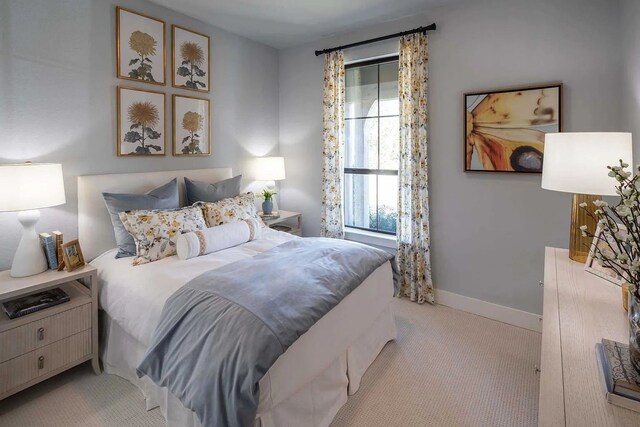 bedroom with light carpet and baseboards