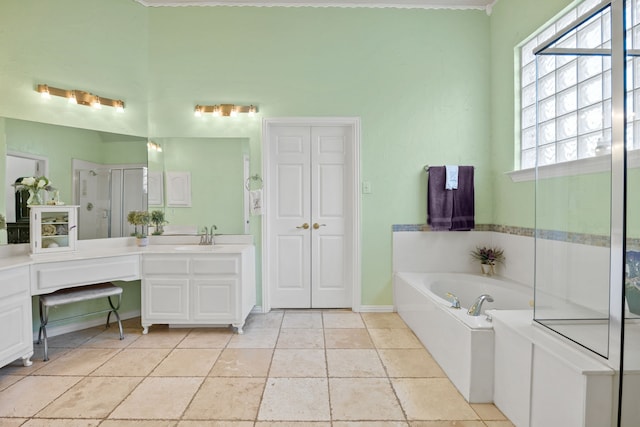 full bath featuring vanity, baseboards, a bath, and a shower stall