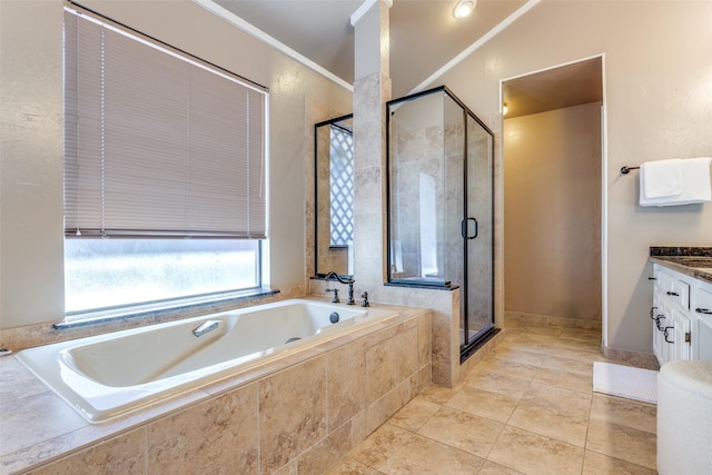bathroom with a stall shower, a garden tub, tile patterned flooring, and vanity