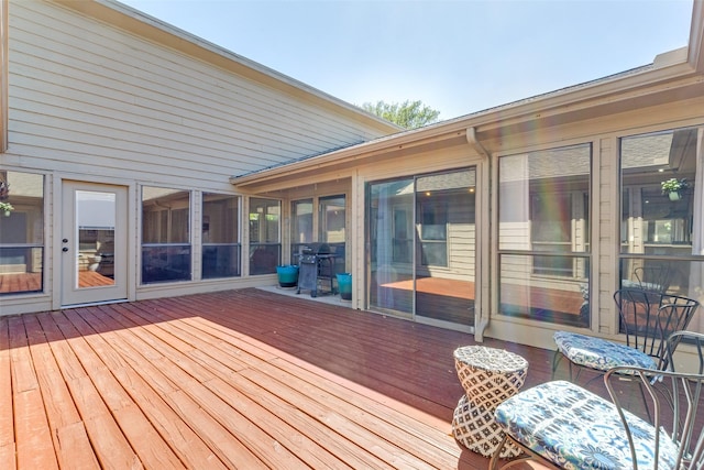 deck featuring grilling area and a sunroom