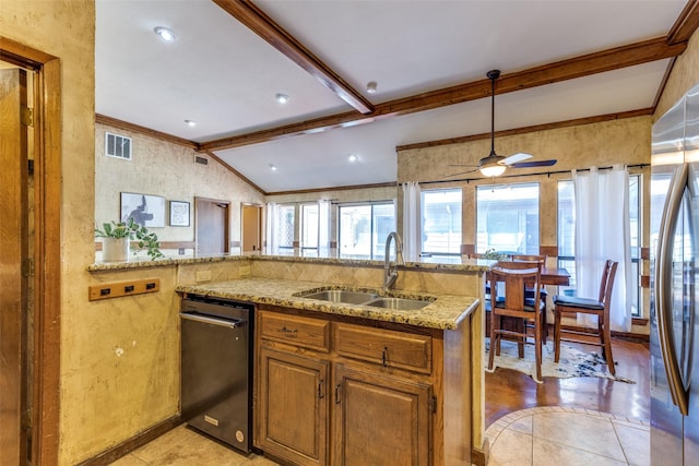 kitchen featuring a sink, black dishwasher, vaulted ceiling with beams, a ceiling fan, and light stone counters
