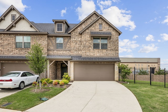 craftsman inspired home with brick siding, fence, a front yard, concrete driveway, and an attached garage