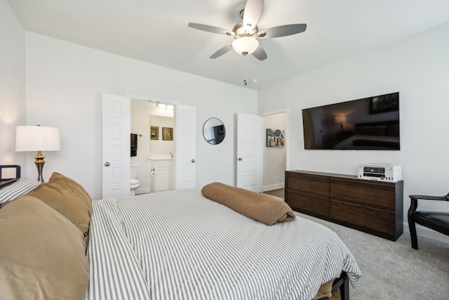 bedroom with baseboards, ceiling fan, carpet floors, and ensuite bathroom